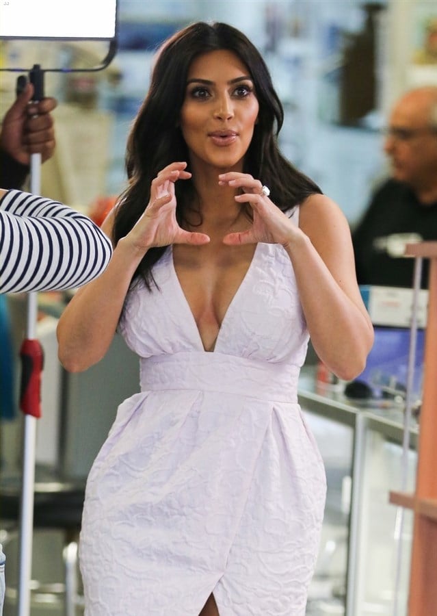 Kim Kardashian Makes Obscene Gesture While Showing Cleavage