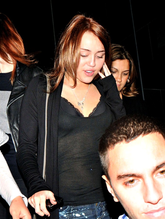 Miley Cyrus In A See-Through Shirt And Black Bra