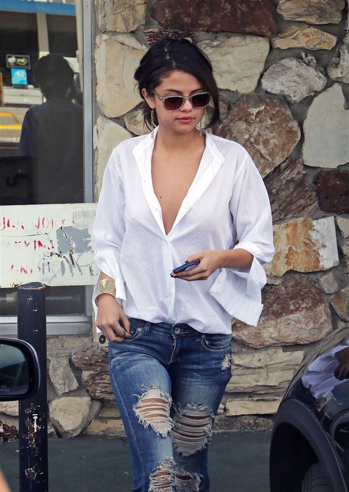 Selena Gomez Unbuttons Her Shirt For The Paparazzi